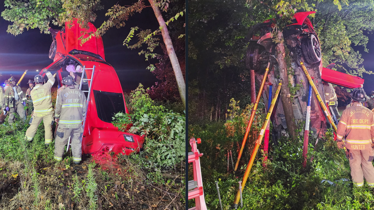 A car hung from a tree in northeast Charlotte, N.C., on Friday, Aug. 25, 2023 at about 3:20 a.m. Two children and a woman were inside, police said.