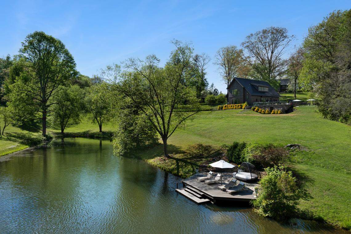 A drone shot of one of the ponds captures one of the guest cottages overlooking a pond.