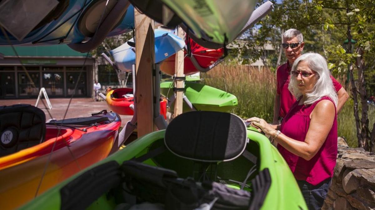 
Marie and John Koski admire some new kayaks at L.L. Bean while on vacation in Freeport, Maine, July 22, 2015. The Koskis, who prefer volunteer and adventure vacations for the cost savings, are part of a growing group of vacationers 50 and older who are finding creative ways to travel economically. 
