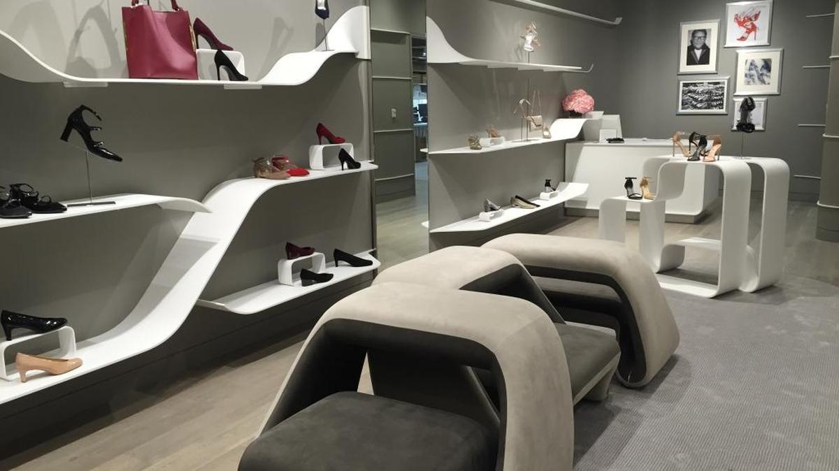 There are lots of curves in the new Stuart Weitzman store in SouthPark Mall, like these suede benches for trying on shoes and the white shelving that lines the walls.