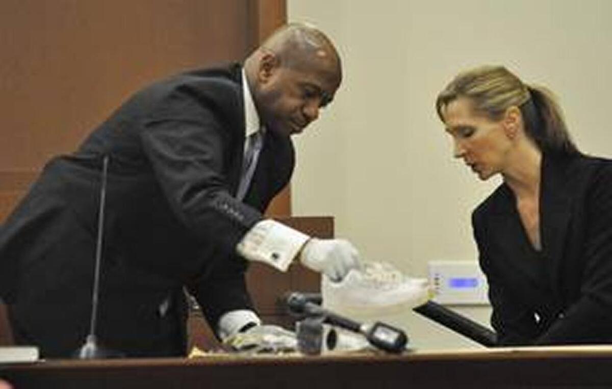 McFadden’s French cuffs and cufflinks show during testimony in a trial.