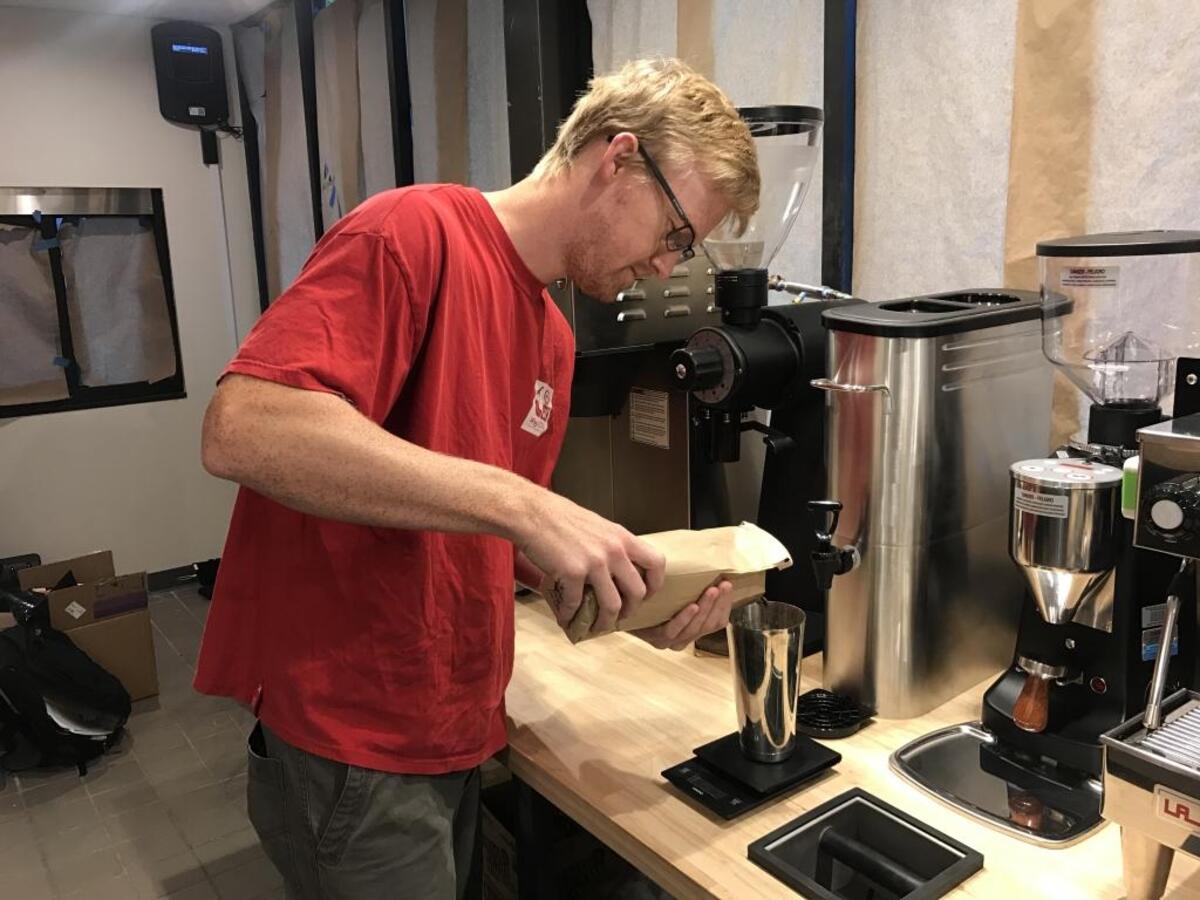 Ian Kolb weighing coffee beans at CupLux.