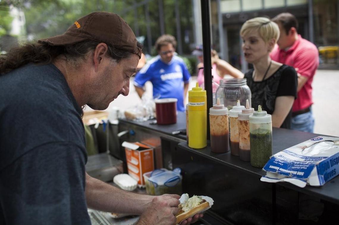 Vic the Chili Man serves hot dogs from his cart in uptown Charlotte in 2016.