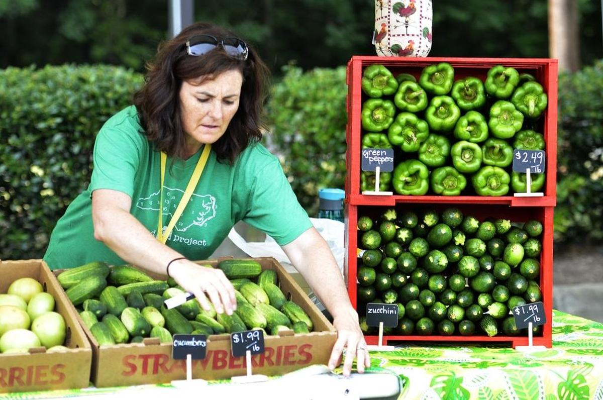 Shannon Hart, with Shady Oaks Farm, prepares her booth at the Rosa Parks Farmer’s Market.