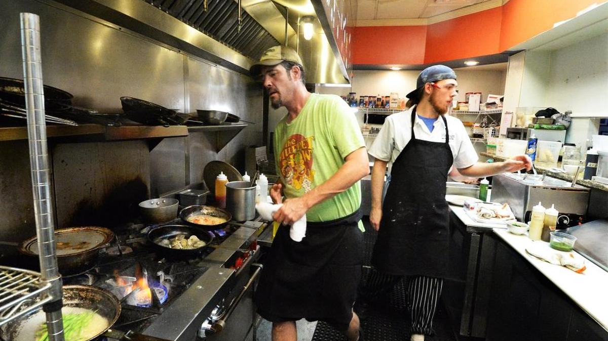 Chef Paul Verica, left, and his son and assistant chef Alex Verica working together in the small kitchen at Heritage Food and Drink in Waxhaw.