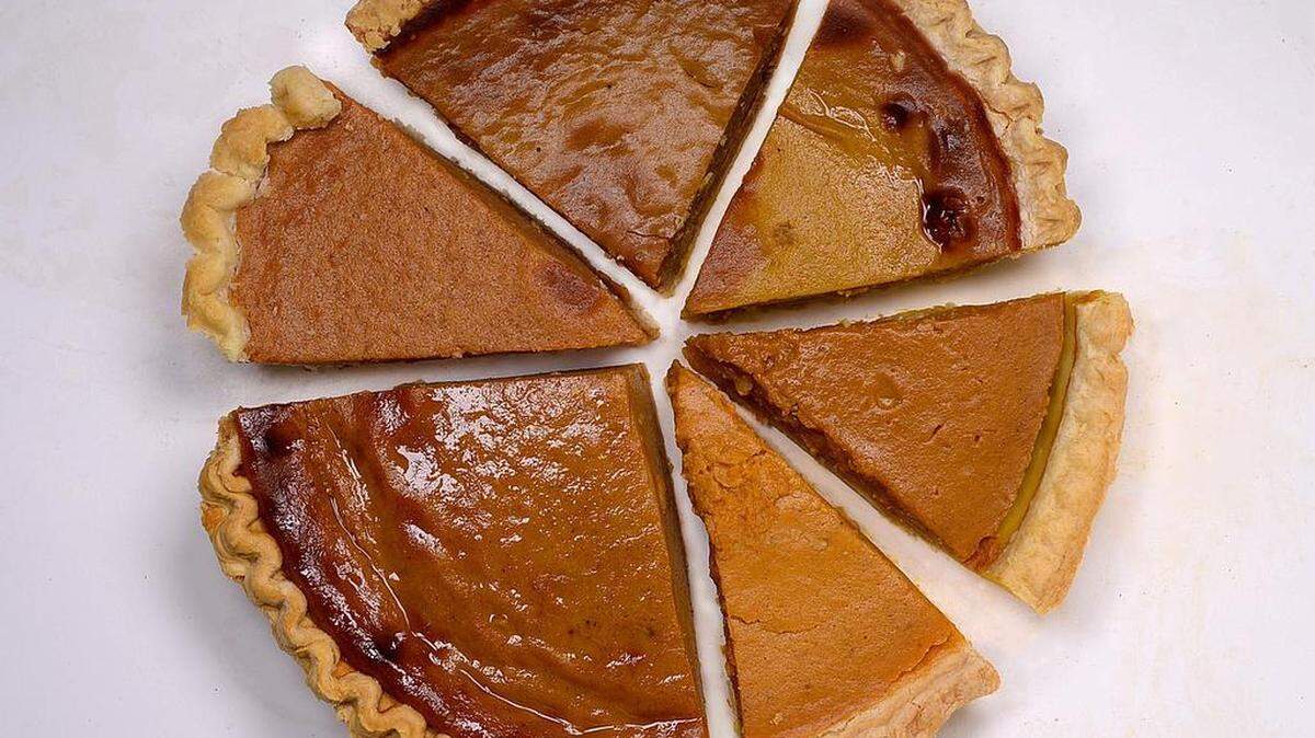 Bottom left clockwise are pumpkin pies from Whole Foods (the big piece), Harris Teeter, Fresh Market, Publix, Trader Joe's and Costco (front right).