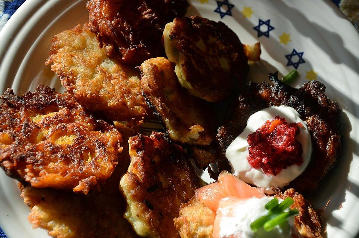 The great thing about latkes is all the ways you can make and top them, including sweet potato with candied ginger and cranberry sauce and potato latkes topped with smoked salmon and a little green onion.