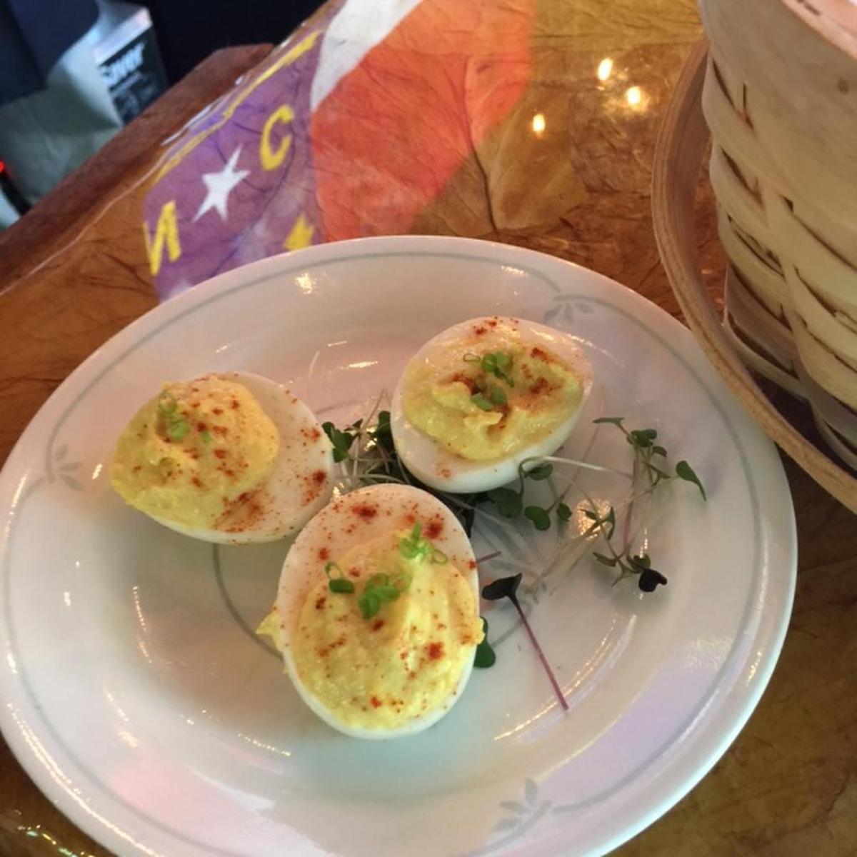 Deviled eggs at the preview for The Packhouse, where the eye-catching wall art is a large N.C. flag.
