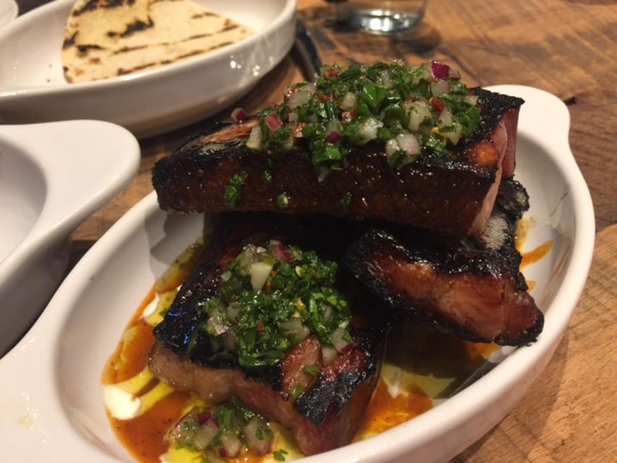 House Bacon is thick slices like pork belly, but firmer and chewier like bacon. The citrus barbecue sauce and crema come together in a sop-worthy sauce; for $1 extra, you get a few corn tortillas if you need them.