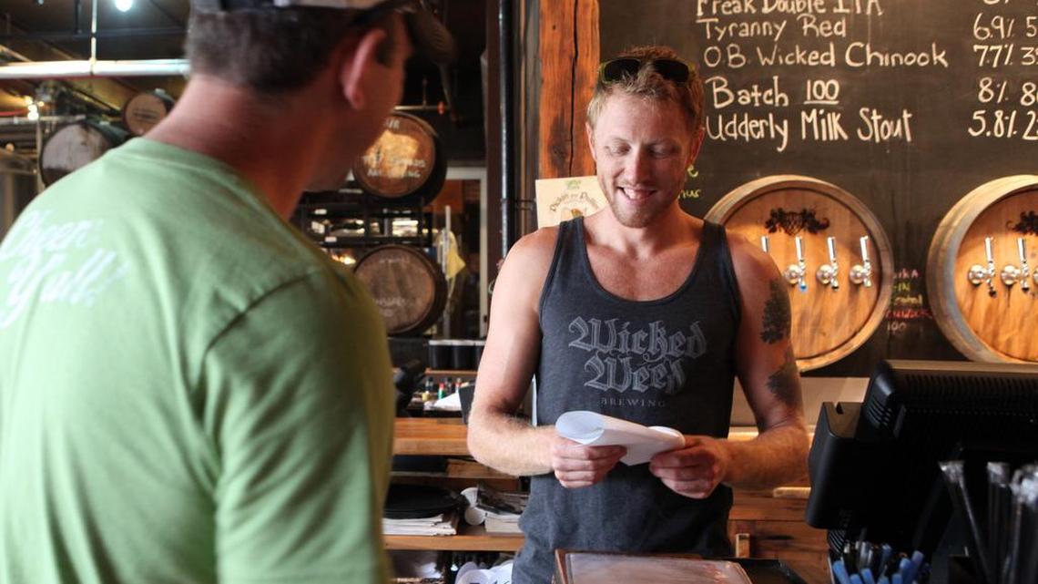 Walt Dickinson, right, is one of the co-owners and creators of the specialty craft beers at Wick Weed in Asheville.