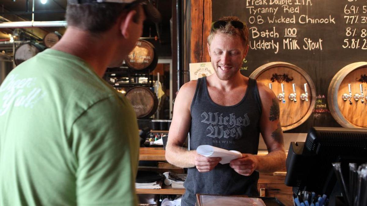 Walt Dickinson, right, is one of the co-owners and creators of the specialty craft beers at Wick Weed in Asheville.