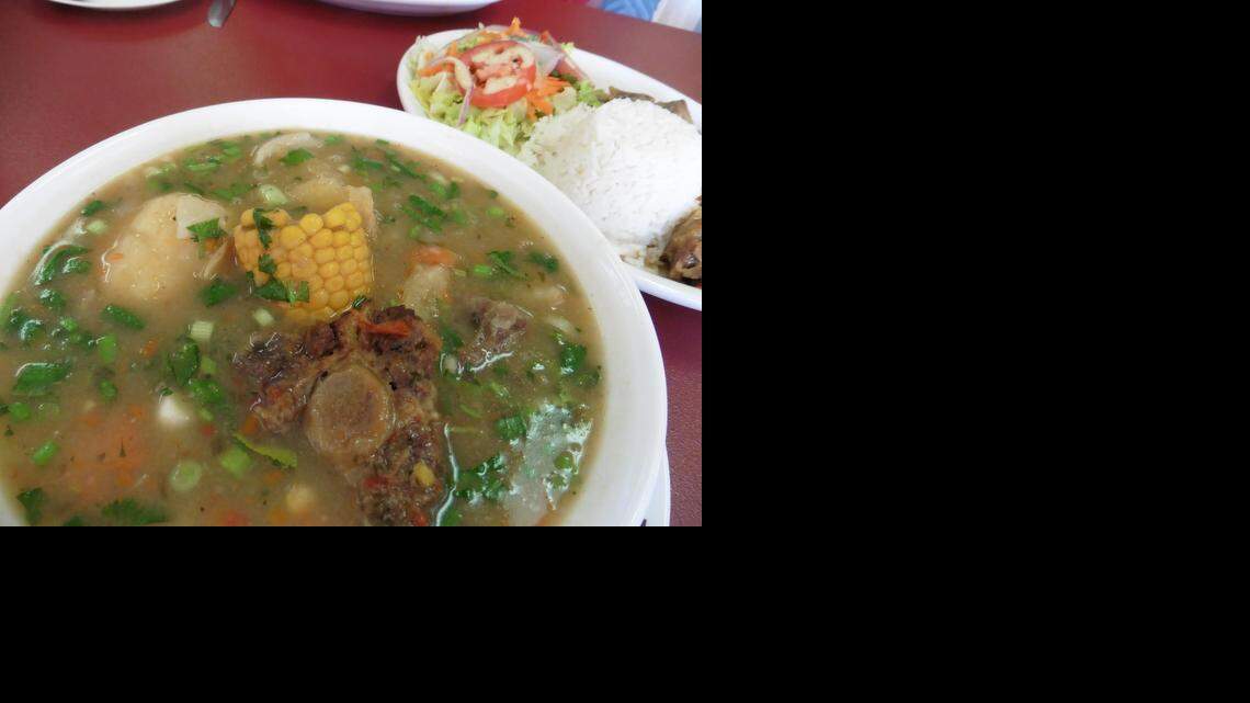 
Sancocho –Colombia’s national soup and the signature dish at Gil’s Kitchen in Charlotte. Broth, potatoes, potato-like yucca, carrot and plantain chunks, and bits of onion simmer together for hours. Chicken or oxtail cook separately til spoon-tender. Minutes before serving, Maria adds the meat plus corn-on-the-cob and a sprinkle of cilantro. On a separate plate there’s a hillock of white rice to spoon into the soup, as well as a salad. It’s a comforting meal for a spring day.
