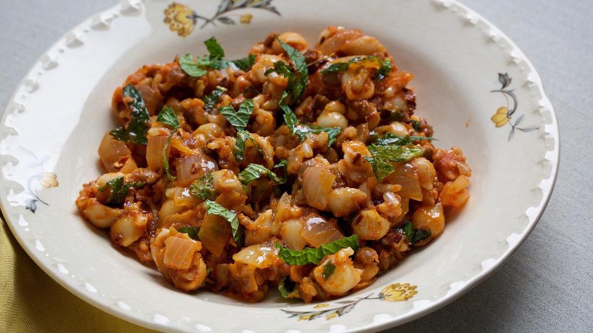 Koshary combines cooked lentils with cooked pasta or rice with tomato sauce and a topping of spiced, melted butter.