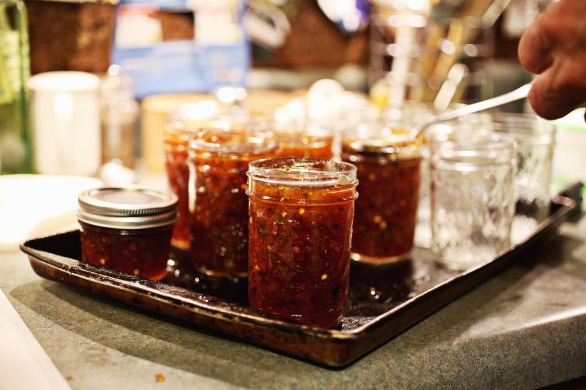 Mike Richardson fills jars with his ribbon-winning pepper jelly at his Raleigh home, Oct. 24, 2017. Richardson has won several ribbons over the years from the N.C. State Fair for his jellies and preserves. He makes several recipes annually to give away to friends for the holidays.