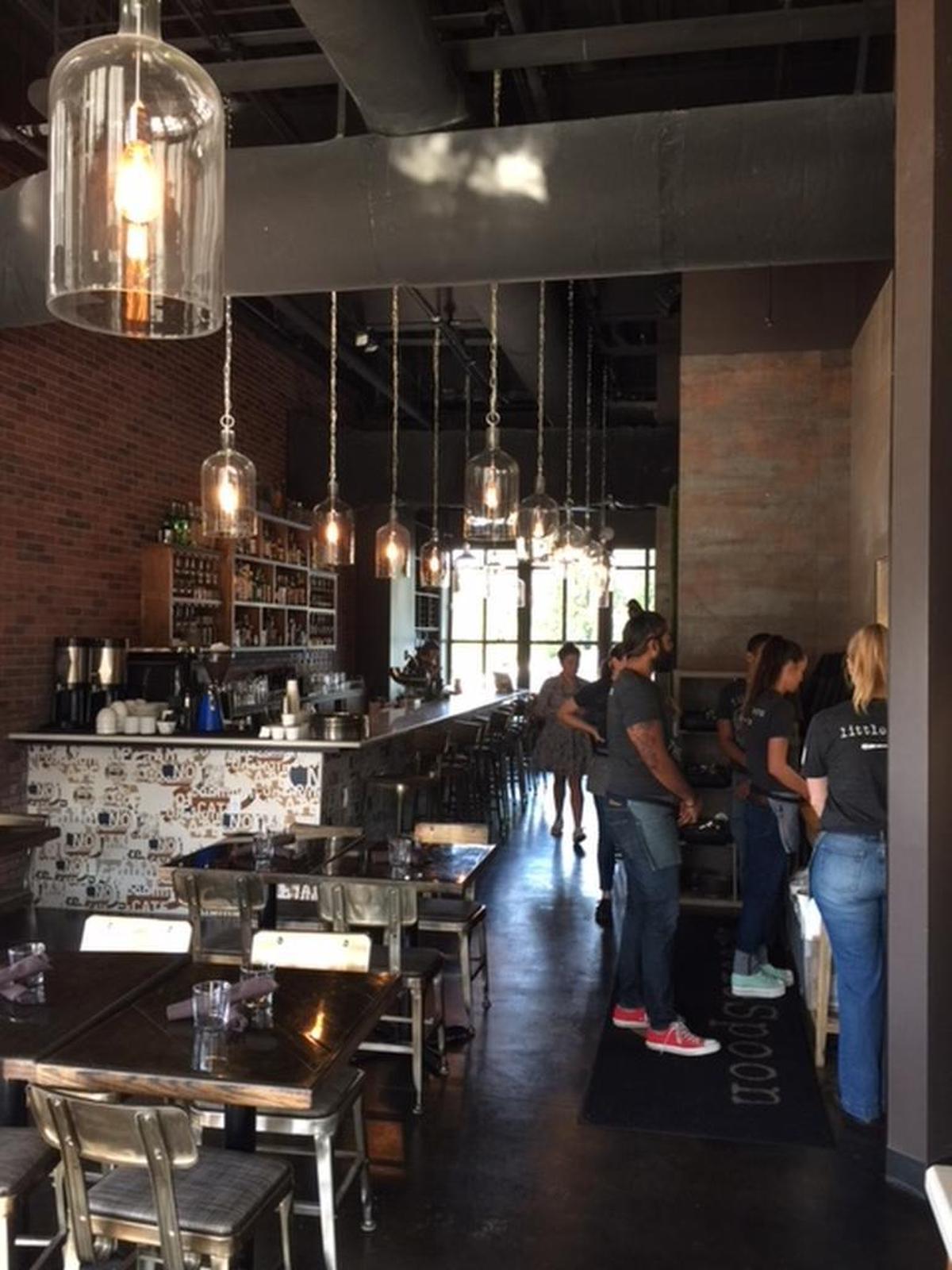 The old/new littleSpoon space now has a full bar, new lighting and a few touches from Comida, including the fake-grass wall and the ice shaver.