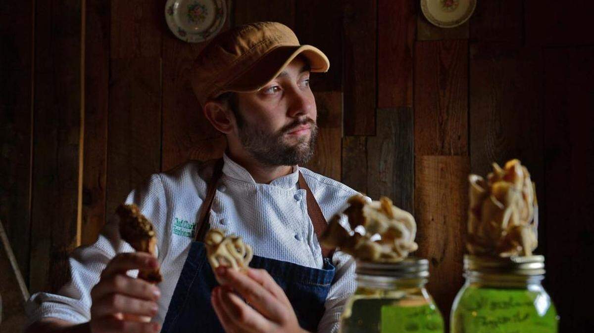 Chef Clark Barlowe with mushrooms at his Charlotte restaurant, Heirloom. While the interest in wild mushrooms is growing, part of the trend toward locally grown ingredients, serving mushrooms found in the wild is currently a violation of state regulations. So far, however, the county health department has not cited him for the practice.