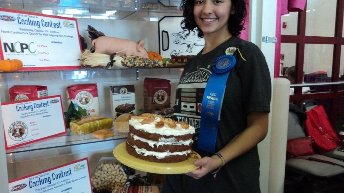 Mary Fuentes, 16, of Charlotte with her wining Autumn Apple Cake.
