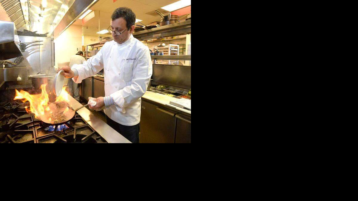 
 Chef Majid Amoorpour, 42, grew up in Iran and Sweden before bringing his culinary talents to the Queen City at his Plaza Midwood restaurant, Bistro La Bon. Here he prepares Saffron Cream Mussels in the kitchen at Bistro La Bon at 1322 Central Ave. 



