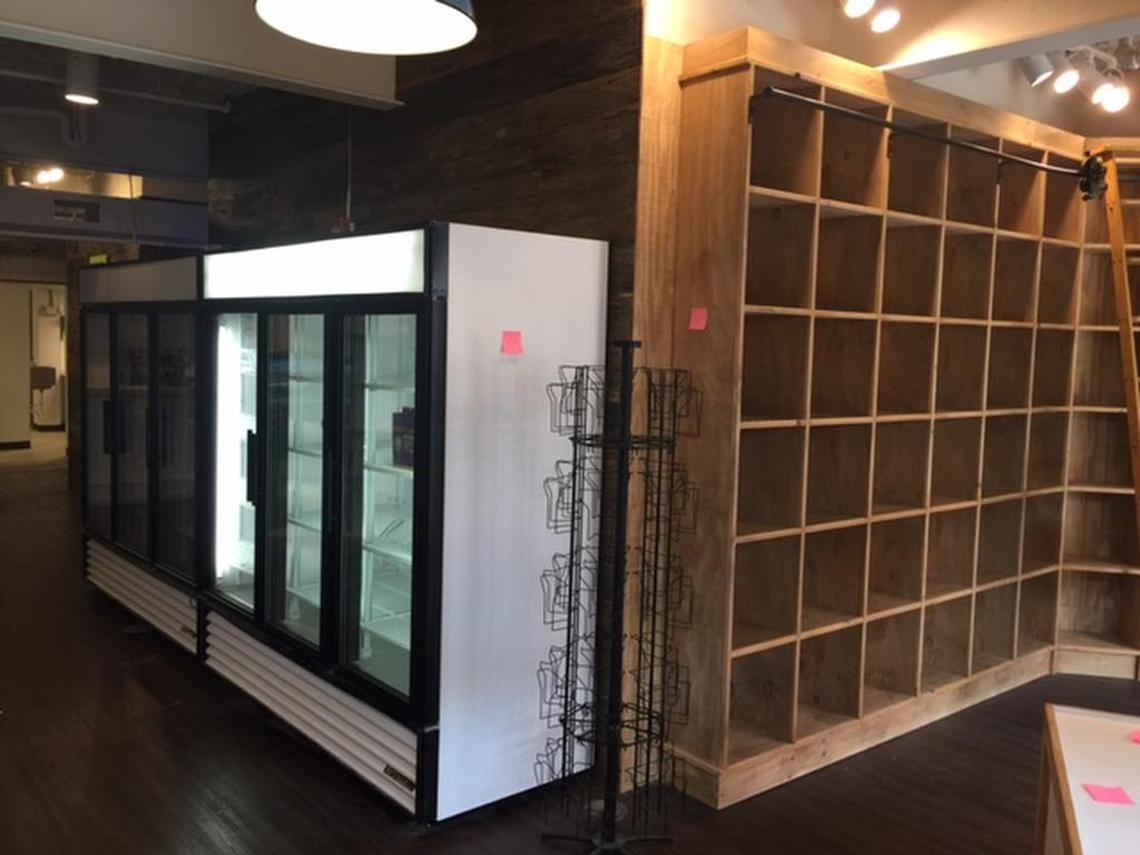 Inside, the refrigerator cases and the wine shelves are ready to be filled in late August.
