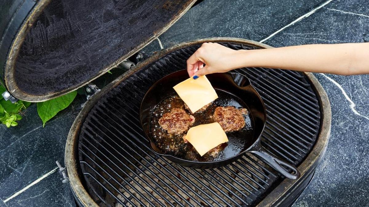 Cook in a cast-iron skillet, even on the grill. You can control the patty better, and the juices don’t drip through the grates.