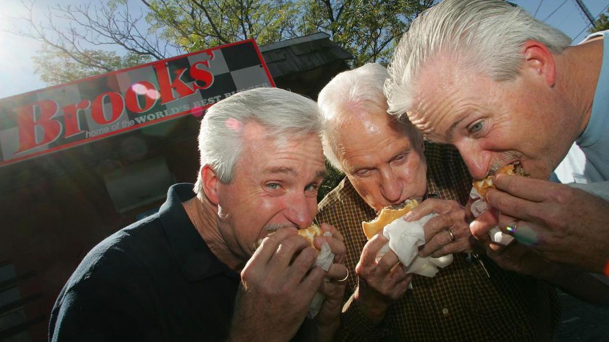 David Brooks, left, and his brother Scott Brooks, right, with their father, Calvin “C.T.” Brooks.