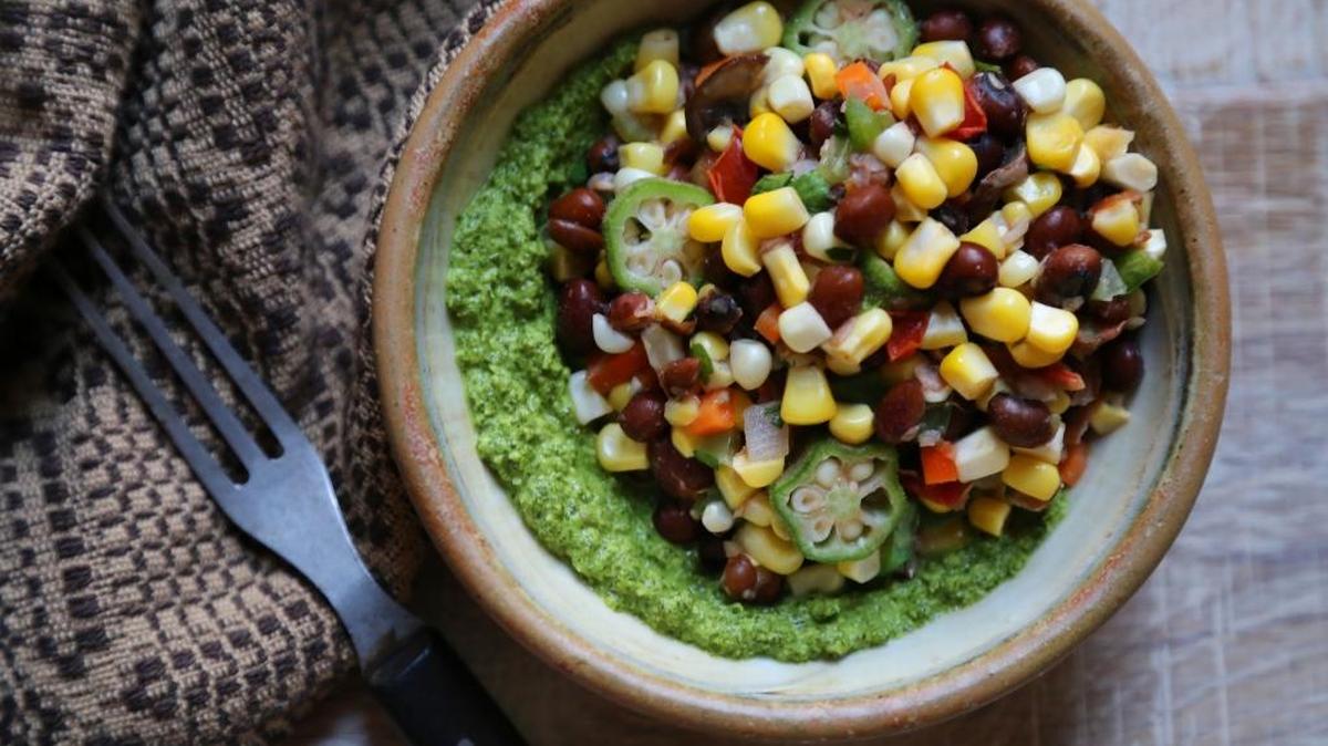 Succotash on a bed of sunflower pesto is a great way to use the last of the summer produce.