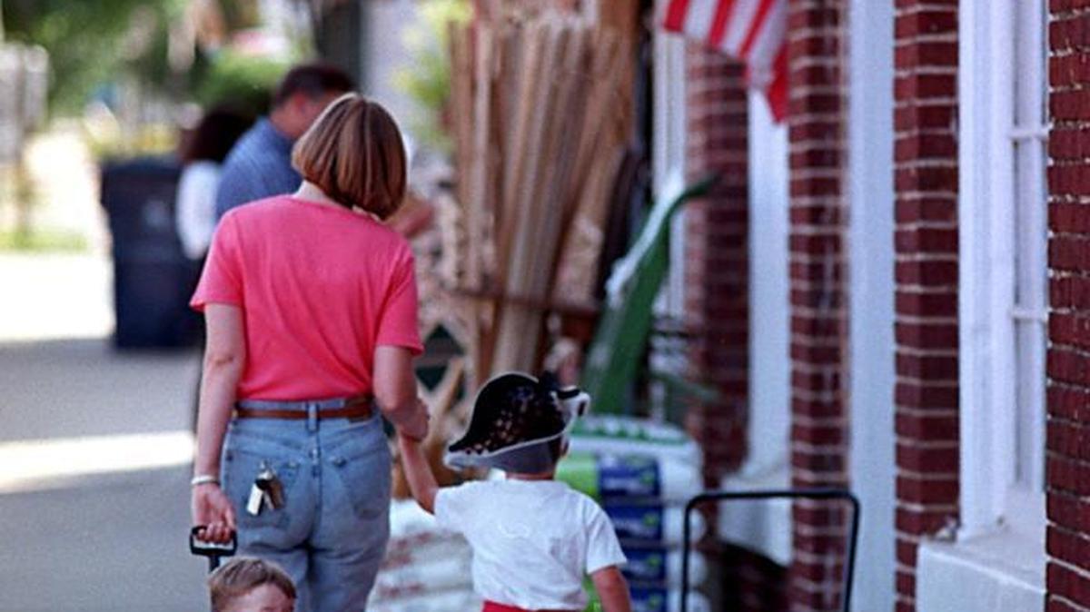 Kristen Williams heads home from the Matthews Community Farmers Market with sons Christopher (left) and Adam Joel in summer of 1997.