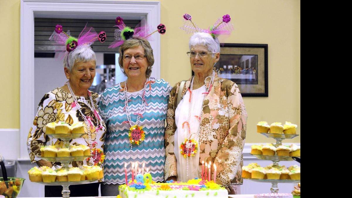 
Jibby Keels, from left, Wilba Helms and Rachel Lemmond prepare to blow out the candles on their birthday cake at their surprise 80th birthday party at Siler Presbyterian Church in Wesley Chapel.
