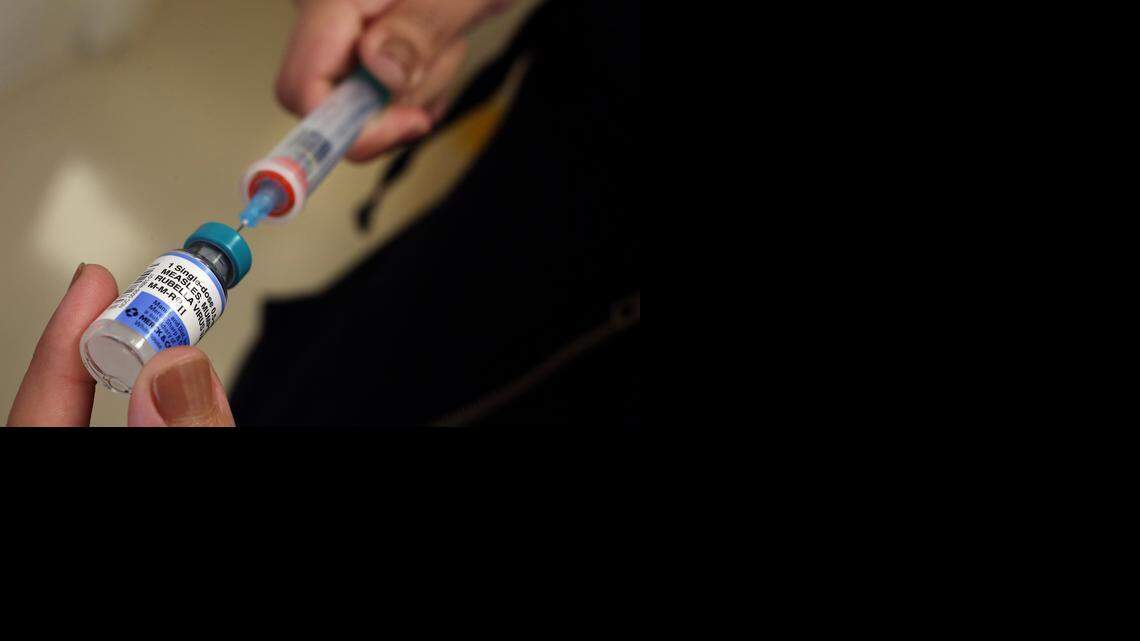 
A vial containing the MMR vaccine is loaded into a syringe before being given to a 1-year-old baby at the Medical Arts Pediatric Med Group in Los Angeles on Feb. 6, 2015. 
