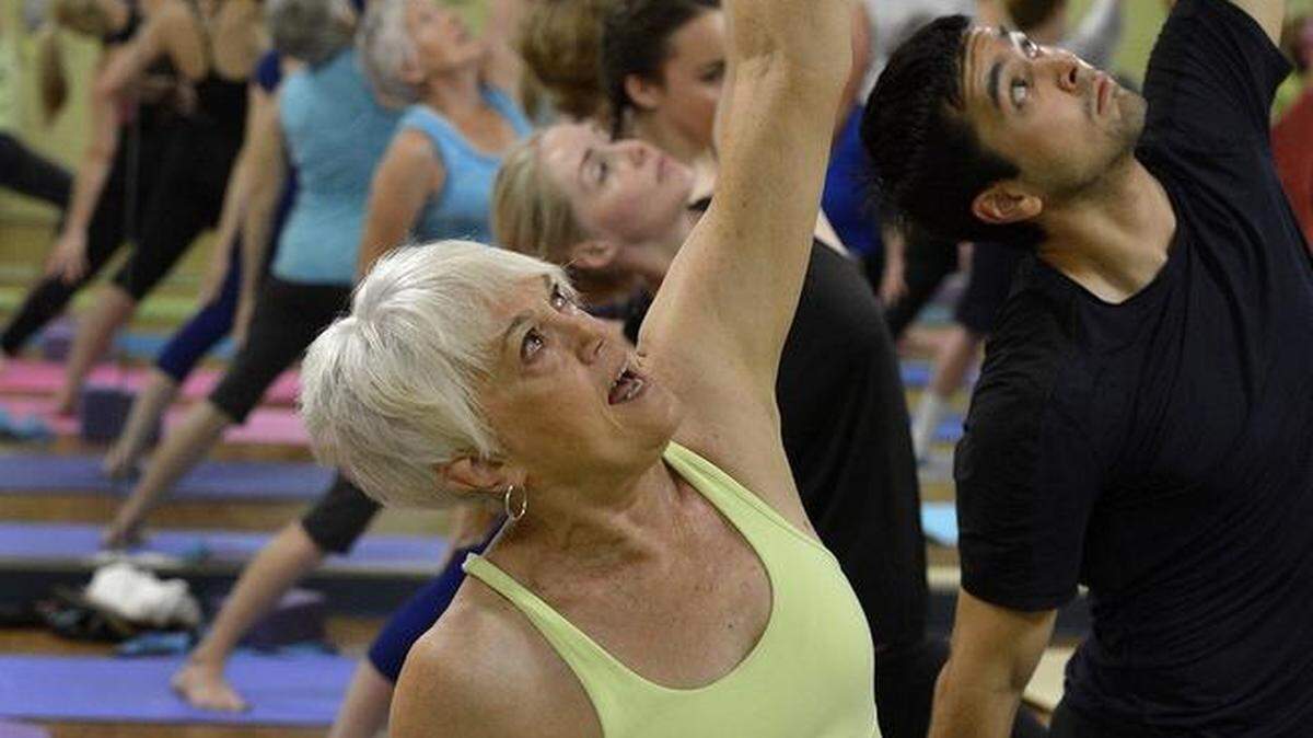 
Yoga instructor Carol Barry during an 8:15 a.m. yoga class for folks over 50 at the Harris YMCA, Tuesday morning, July 14, 2015. 
