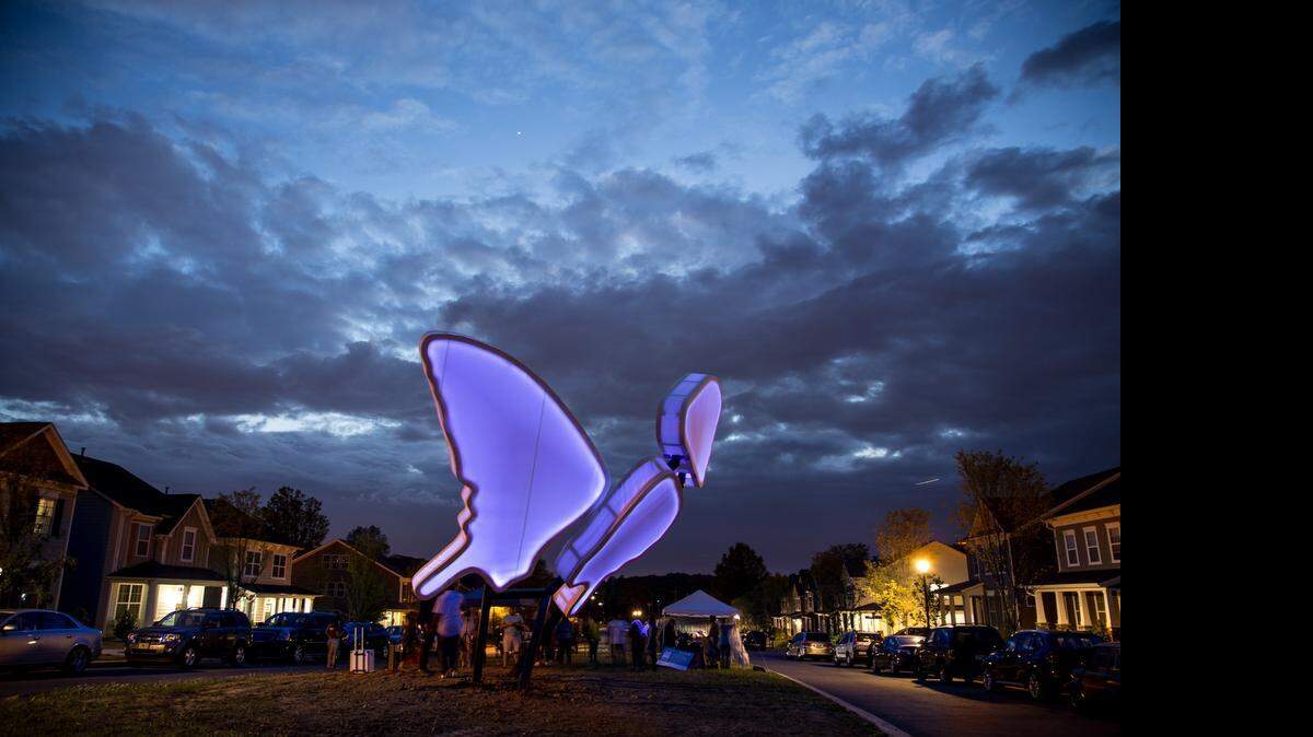 
Brandon Ballengee’s sculpture “Love Motels for Insects” at the Brightwalk neighborhood is best appreciated at night. UV LED lights are behind the white awning. Beneficial insects are drawn to the sculpture, where they can mate.



