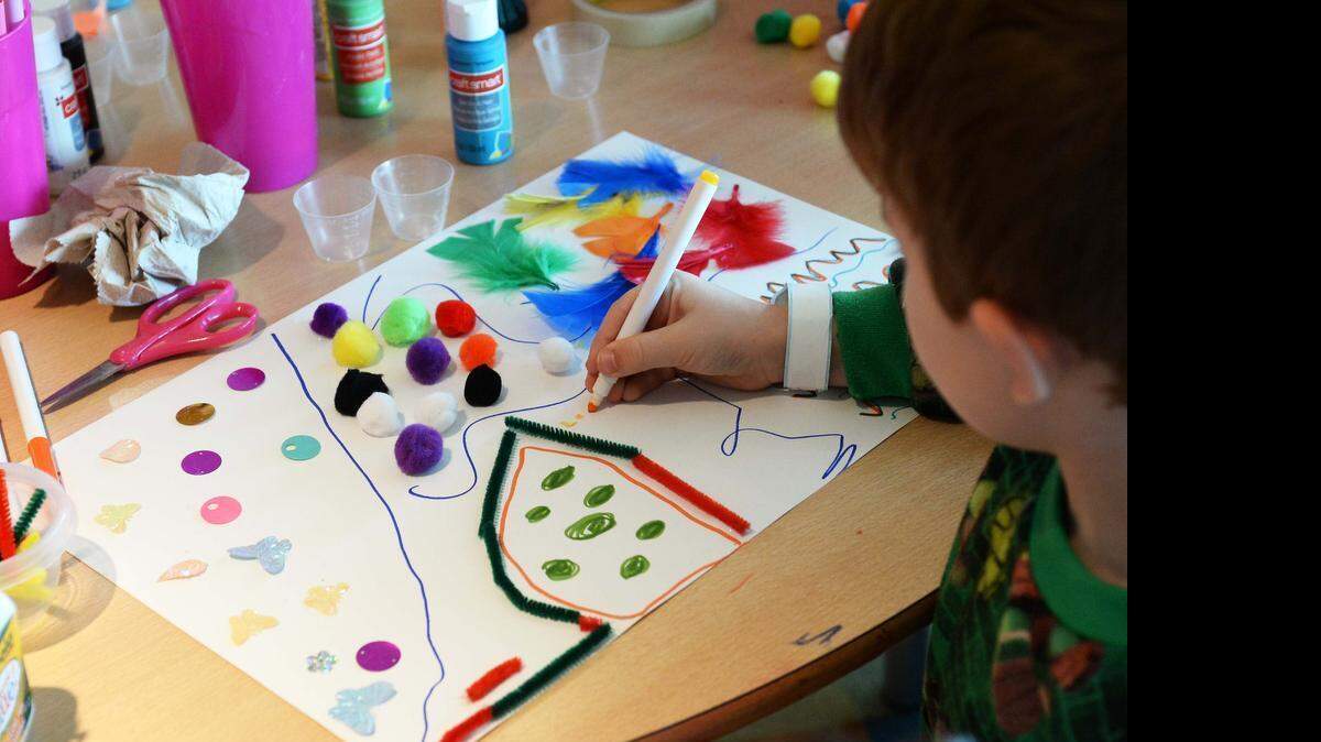 
Logan Engleman, 5, concentrates on his art project in the Levine Children's Hospital playroom June 17, 2015.
