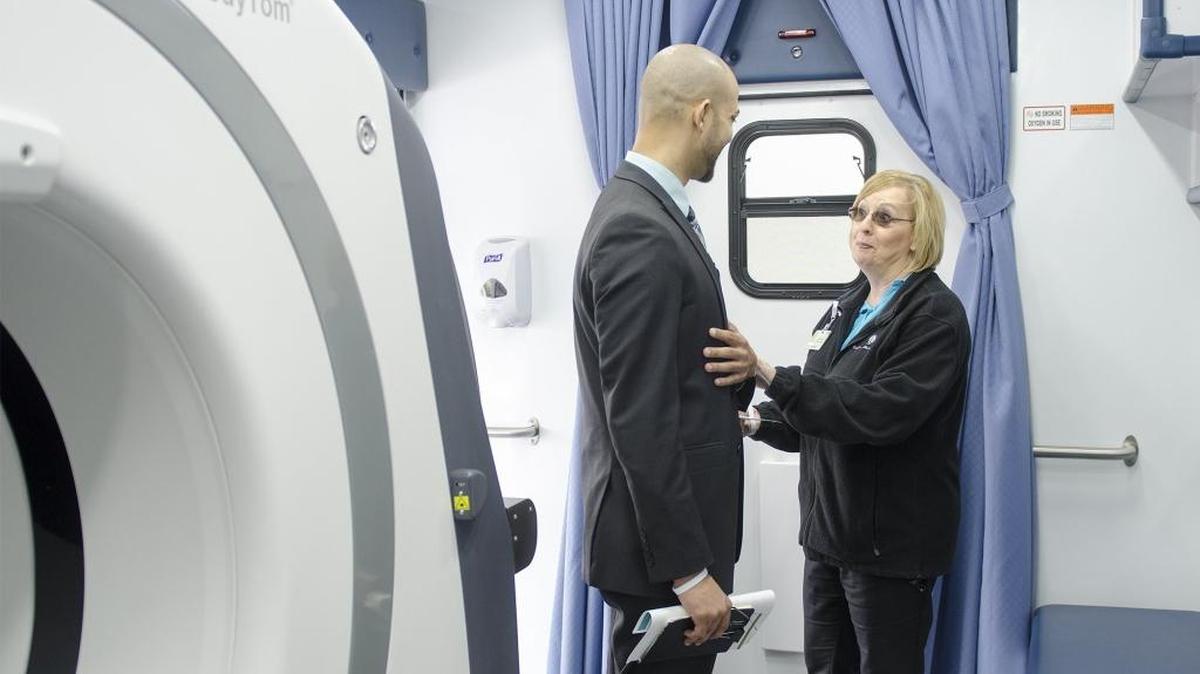 Visitors chat inside of the unit at the Carolinas Healthcare System's Levine Cancer Institute Mobile Lung Screening Launch Event on March 22, 2017.