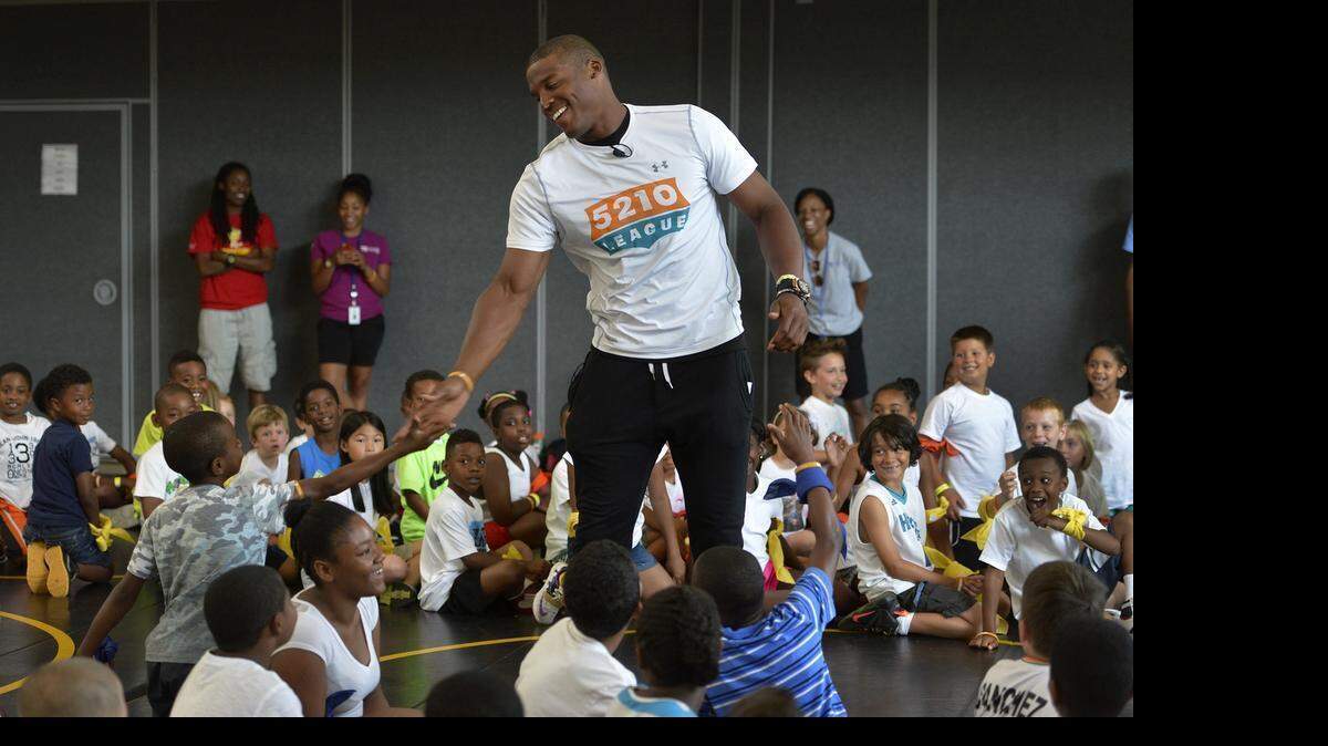 
Panthers quarterback Cam Newton engages with kids at the 'Healthy Together' awareness campaign at Revolution Park, Tuesday June 23, 2015. The superhero-themed campaign encourages healthy habits for the whole family. It urges families to join the '5-2-1-0 League' and pledge to follow healthy habits every day. Cam Newton is featured in the campaign as Action Ace, a hero who leads the 5-2-1-0 League and encourages families to be healthy.
