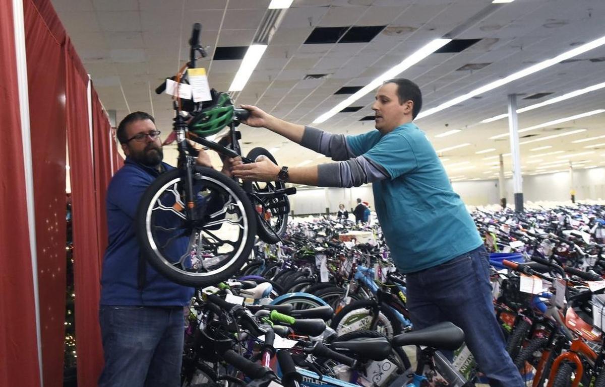 Besides the thousands of bicycles donated by The Spokes Group the general public donated many bikes for children. Jonathan Benton and Dana Johnson, left to right, helped move those bikes donated by the public. The Salvation Army Christmas Bureau program had its annual kickoff on Friday, Dec. 15, 2017. Needy families with children from birth to 12 in Mecklenburg and Union counties will get gifts, some even get bicycles, and food for Christmas.