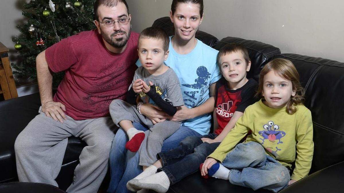The Skatkov family from left, Denis Skatkov, the dad; Crytsal Skatkov, the mom; boys, Mark 6, Dominic 5, Kaiden 3 at their home in Stallings. They have signed up for the salvation army empty stocking program.