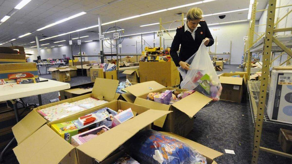 Salvation Army Maj. Susan McElroy chooses gifts purchased through the Empty Stocking Fund for a package for a family that qualified for emergency help at the Christmas Bureau on Tuesday, December 22, 2015.