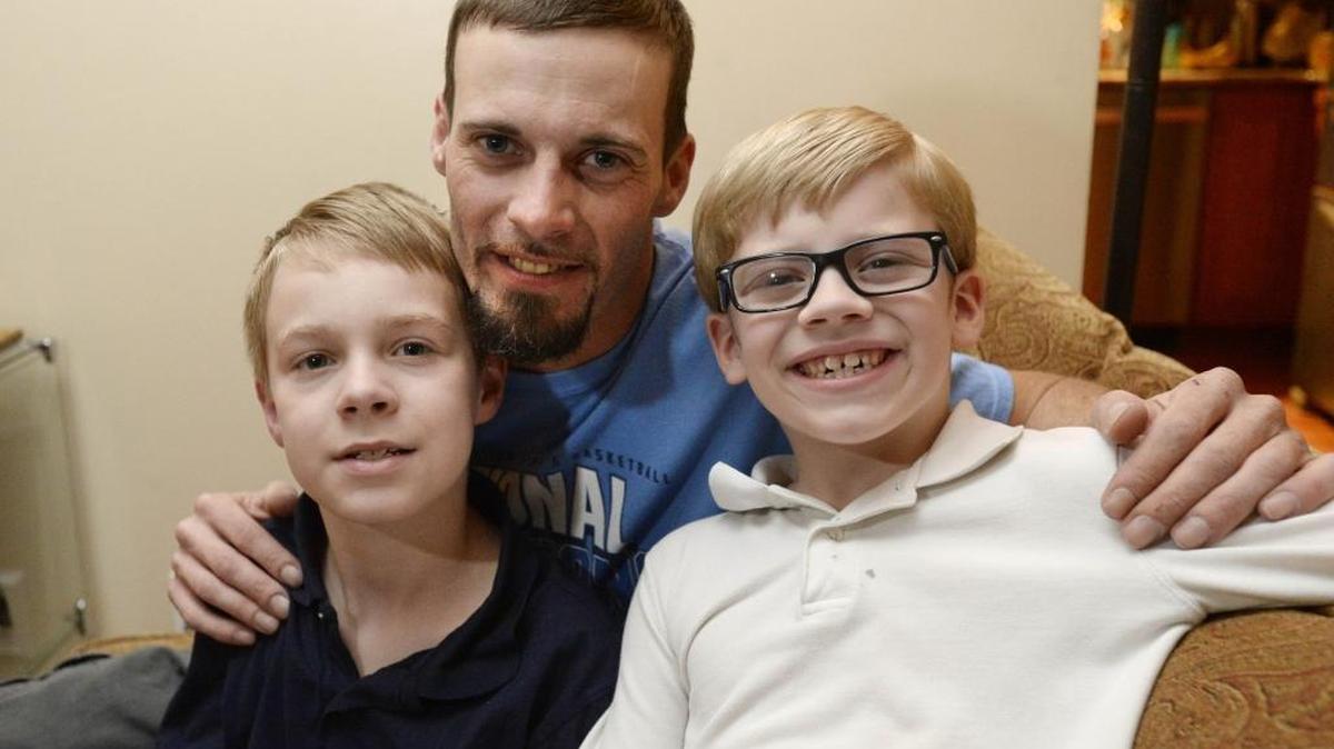 Jeff Stiles and sons Devin , 10, left, and Trevor, 7. Jeff is a new widower, and it’s the first Christmas that he and the boys will mark without the kids’ mother, Tracy, who died in a car crash in October.