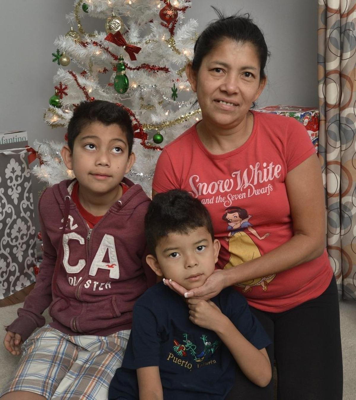 Aida Hernandez and her sons, Eduar, 12, and Edin, 5, who received Christmas toys courtesy of the Salvation Army. Hernandez, a single mom, had two open-heart surgeries, one in May and one in August, and has been unable to work while she recuperates.