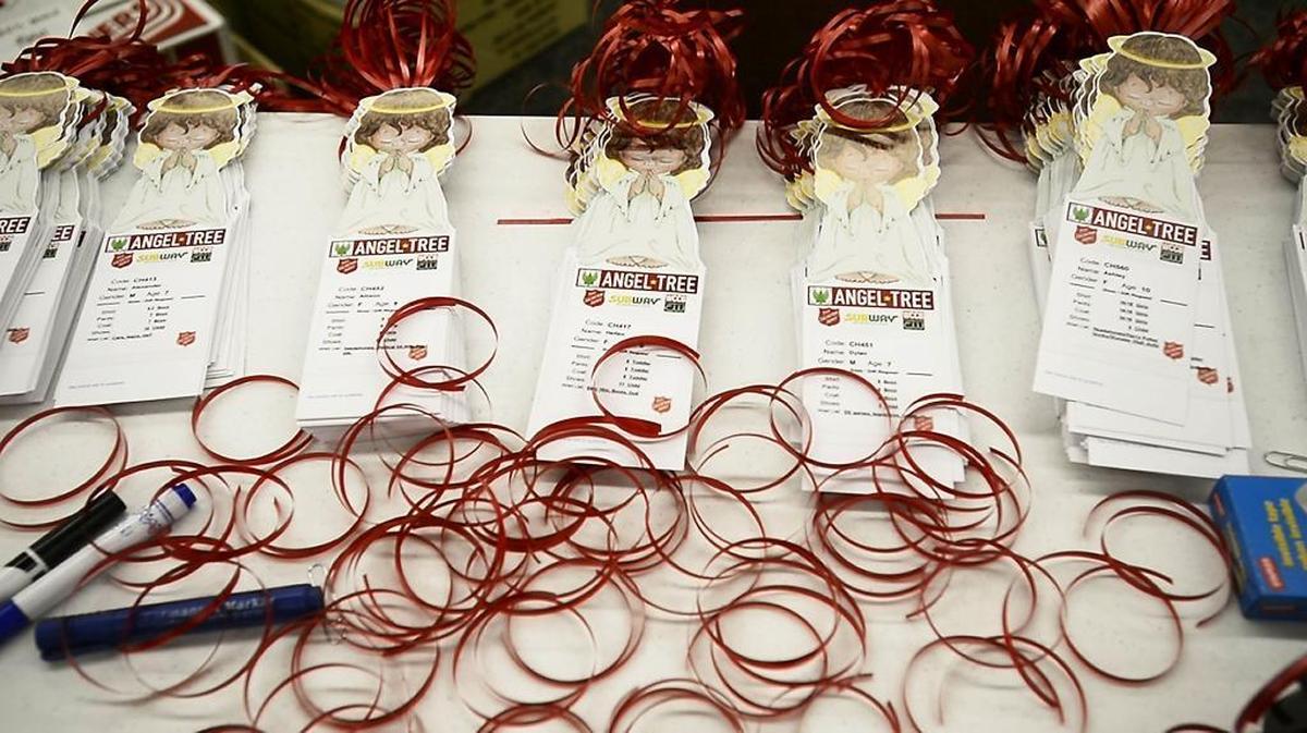 Angel Tree tags are stacked on a table inside the Salvation Army’s Christmas Bureau. The bulk of the children registered with the Salvation Army’s Christmas program will have their names placed on Angel Trees at local malls and businesses in the hopes that someone will take the tag and fulfill their wish.