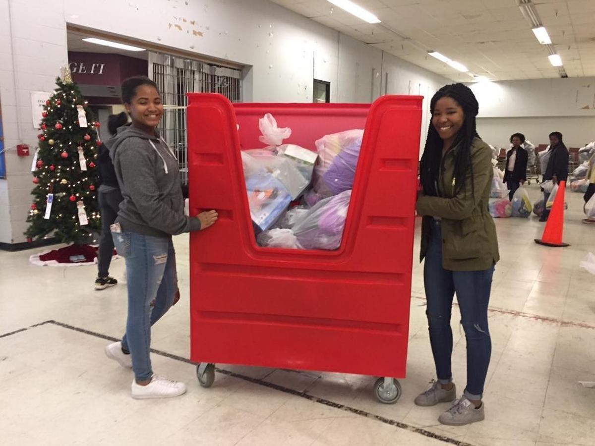 Tamia Dandridge and Madison Robinson unload a cart filled with bags of toys at the Salvation Army Christmas Bureau. The teens were volunteering as members of the Butler High School Black Student Union.