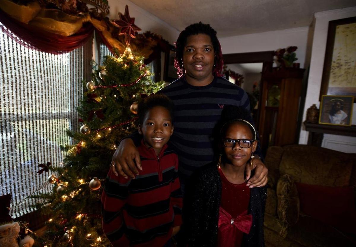 Octavious Young, who adopted his niece Kenyada, 8, right, and nephew, Xzabeon, 11.