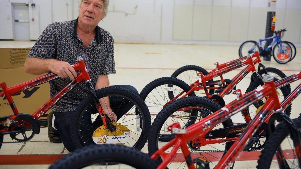 Ira Coleman, 60, puts together hundreds of bikes to be given away by The Spokes Group during the Salvation Army's annual Christmas program. This year, 13,060 children will receive toys through the program.