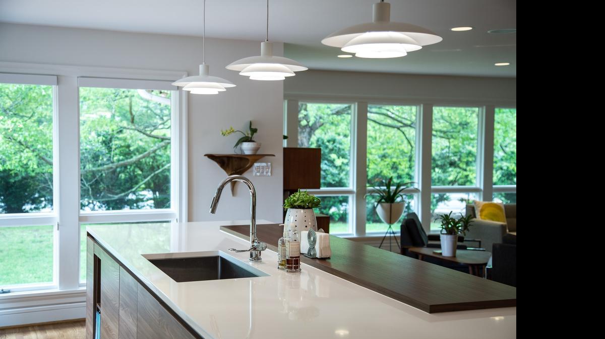 
The kitchen and living room in Ken and Holly Schoolmeester’s midcentury modern home combined for a bright, open living space.
