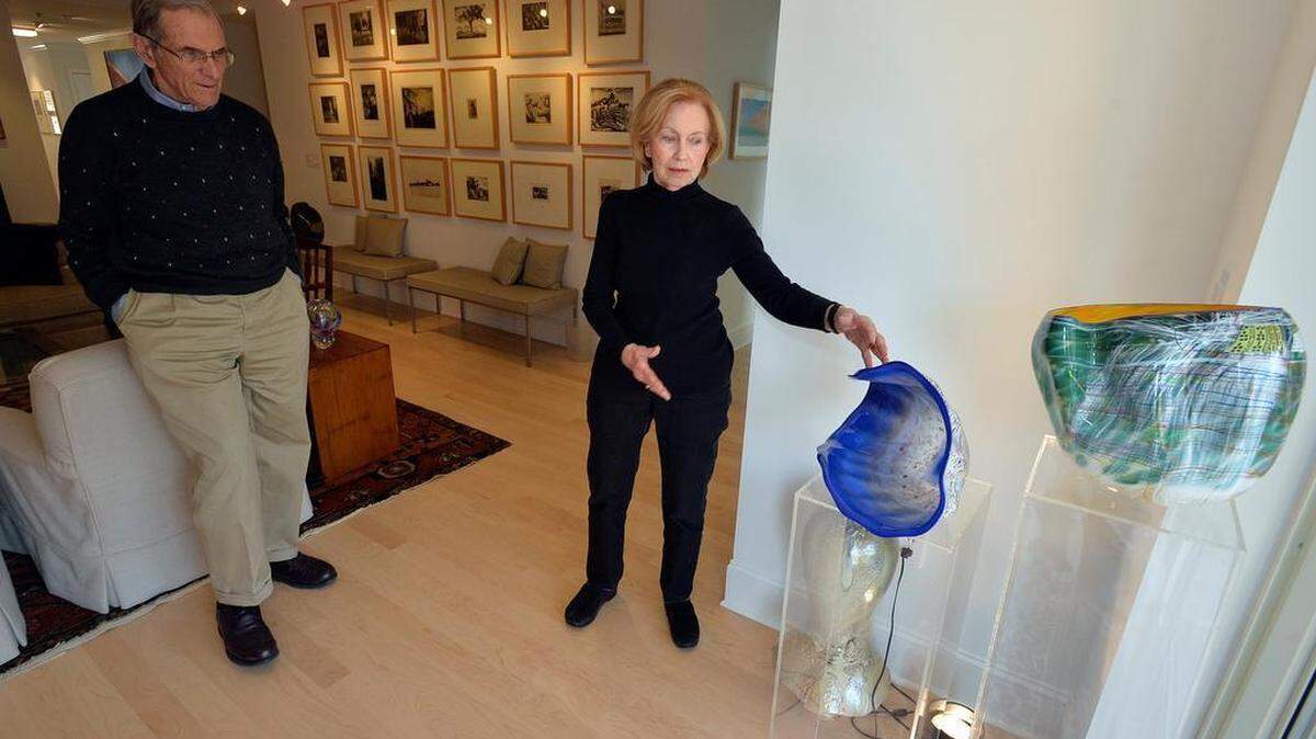 “We can’t live without art,” says Peggy Culbertson, here pointing out Dale Chihuly glass art pieces in their condo at Sharon Towers.