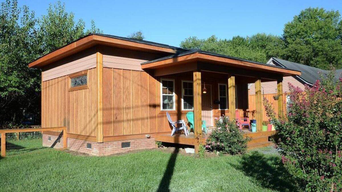
Paul McBroom, longtime NoDa landlord and former co-owner of the Neighborhood Theatre, has three tiny houses in his real estate portfolio. Well, technically, they're not tiny houses at 600 square feet – 100 square feet above the max size most consider tiny. But the zoning designation he used to create these rental units could be used to build tinier homes on a foundation. A large front porch gives the homes more living space.

