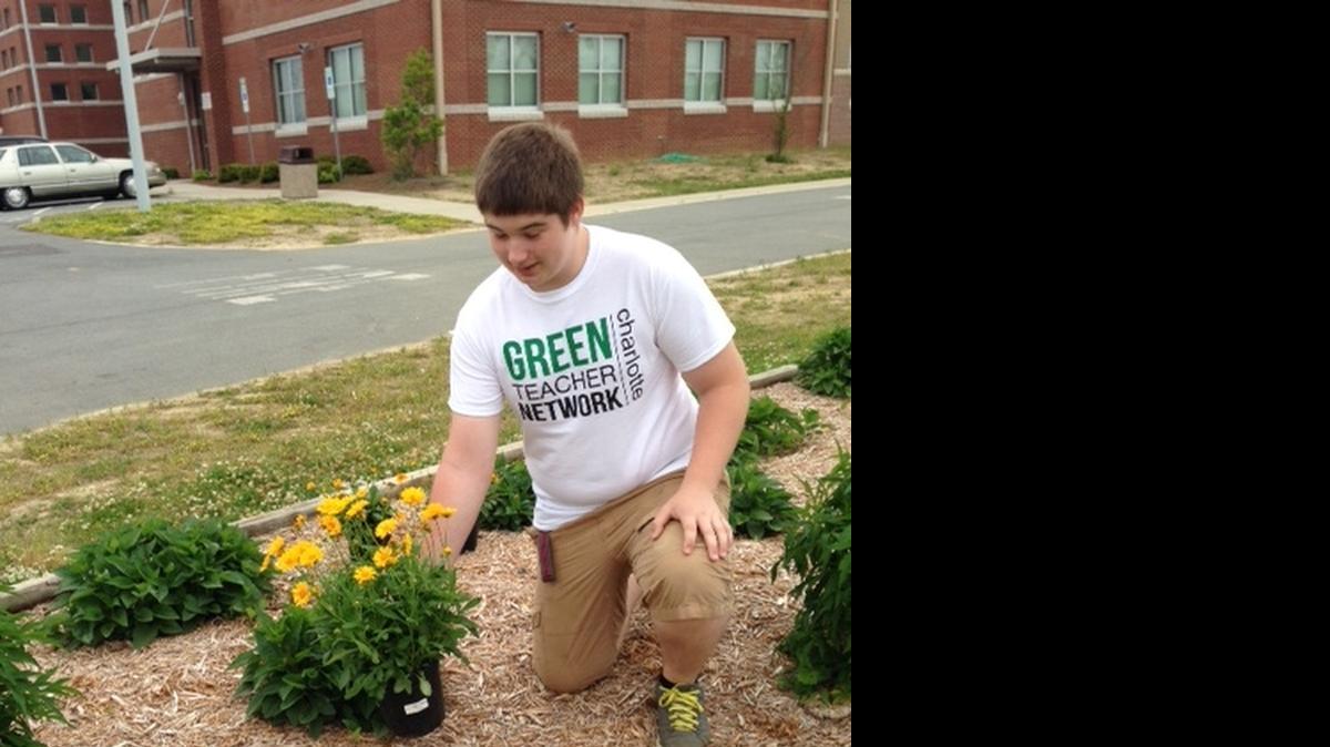 
Chandler Watkins plants a black-eyed Susan at Whitewater Middle School.
