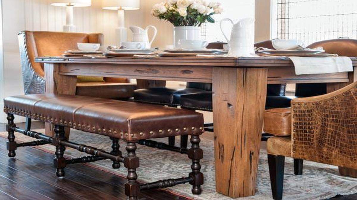 
Farm tables can be casual and inviting. This casual dining room from Alder & Tweed has a wood table, leather bench and host chairs. 
