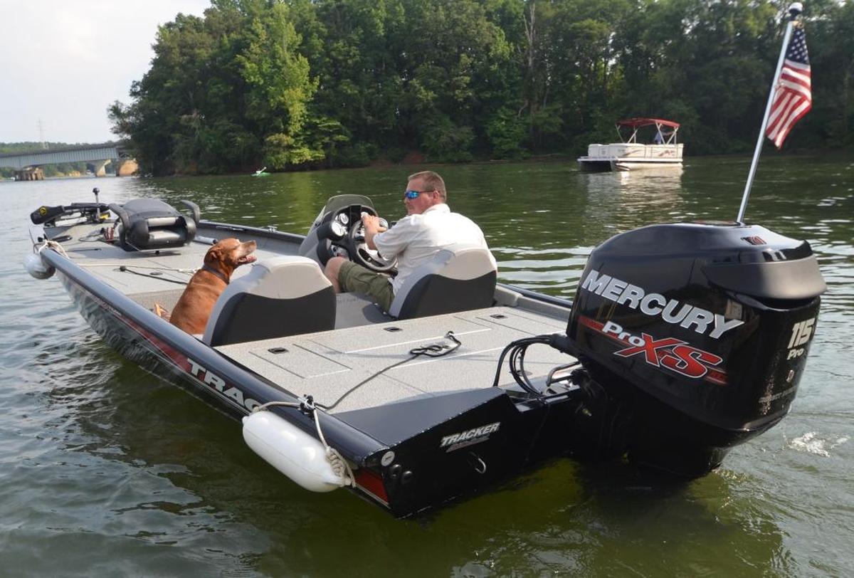 Gypsy the dog gives her approval to owner Dean Walker of Gaston County of a July cruise on Charlotte’s Mountain Island Lake in Walker’s four-month-old bass boat.