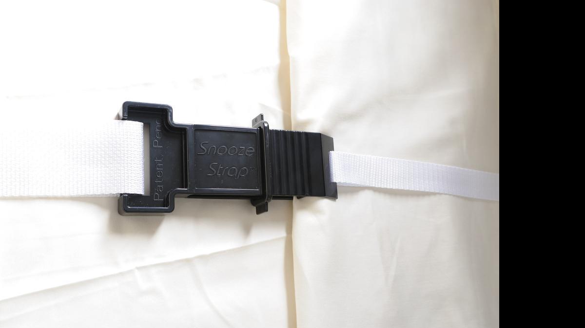 
Snooze Strap holds covers in place at bedtime. Unfasten it at other times.
